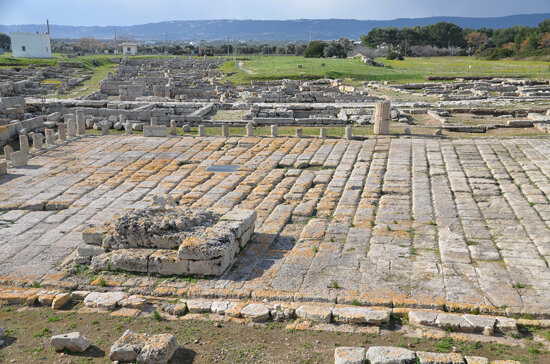 The Roman forum, it was paved with regular blocks of tufa and enclosed by a portico with Doric colum